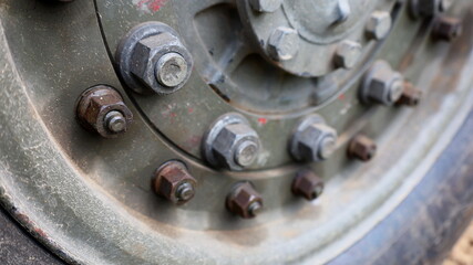 Nut with bolts on old truck wheels. Close up and selective focus.