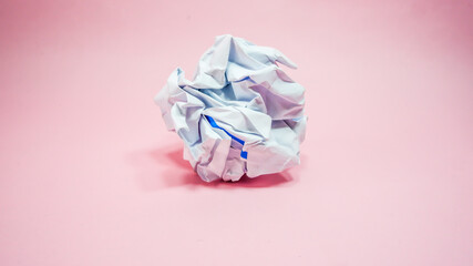 Crumpled paper in pink background