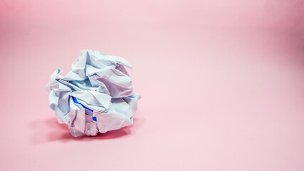 Crumpled paper in pink background