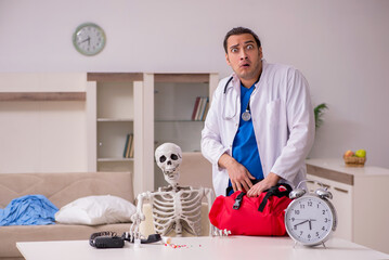 Young male paramedic visiting skeleton patient