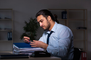 Young businessman working late in the office