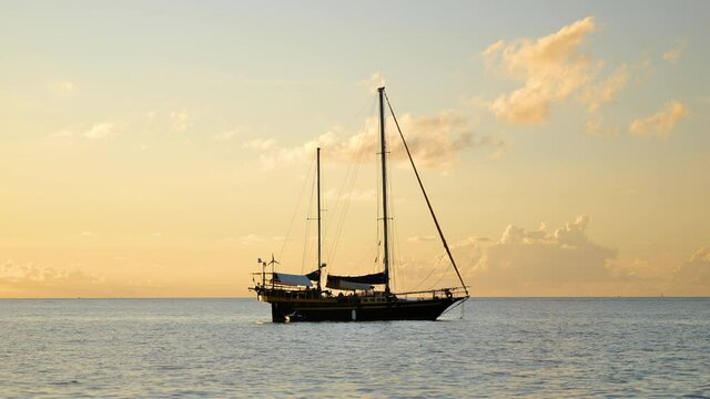 sailboat in the sunset Martinique beautiful vessel with two mast anchorage location