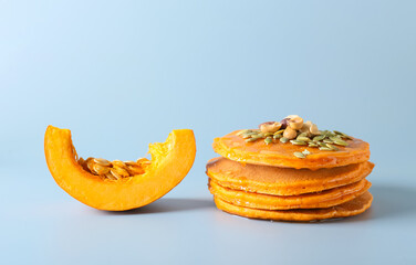 Tasty pumpkin pancakes on grey background