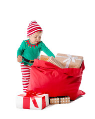 Cute little baby in elf's costume and with Santa bag on white background