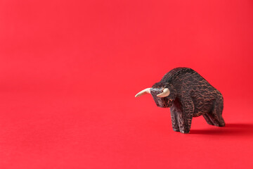Figurine of bull as symbol of year 2021 on color background