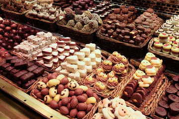 A large variety of sweets and cakes on confectionary display.