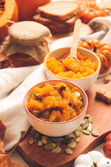Bowls of tasty pumpkin jam on table