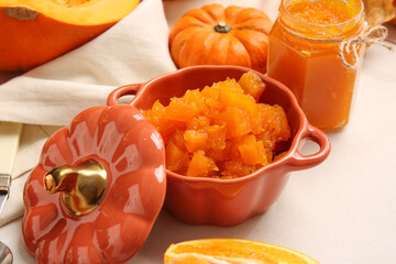 Pot of tasty pumpkin jam on table