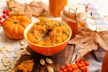 Bowl of tasty pumpkin jam on table