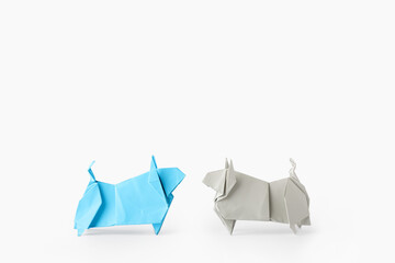 Origami bulls as symbol of year 2021 on white background