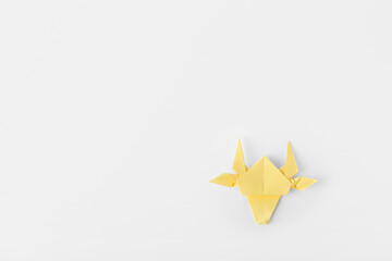 Origami bull as symbol of year 2021 on white background
