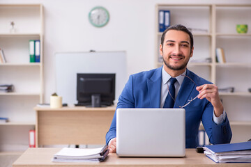 Young male businessman employee working in the office