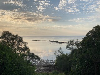 Morning sunlight on very still waters of bay, view from top path 1