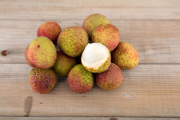 There is a bunch of fresh lychees on the table