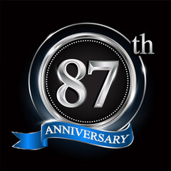 87th anniversary logo with silver ring and blue ribbon.