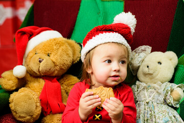 Little cute baby on the christmas tree, funny kids face.