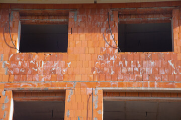 facade of a new brick house under construction