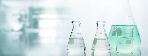 flask and beaker in chemistry science laboratory banner background