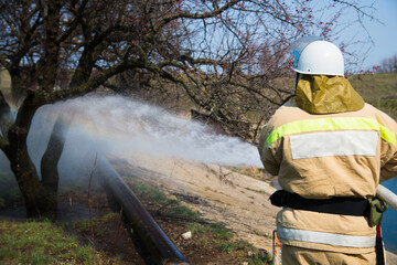 Firefighter extinguishes a fire