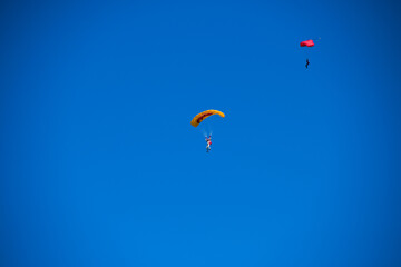 Parachutist on the background of blue sky