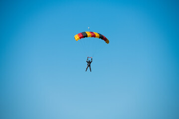 Parachutist on the background of blue sky