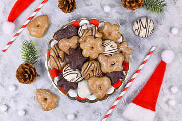 Plate with traditional German gingerbread cookies with sugar and brown and white chocolate glazing...