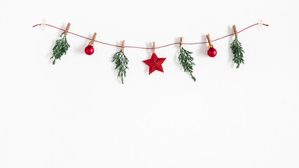 Christmas composition. Garland made of red balls and fir tree branches on white background. Christmas, winter, new year concept. Flat lay, top view - 389547367