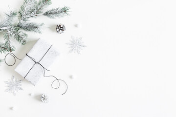 Christmas composition. Gift box, fir tree branches, decorations on white background. Christmas,...