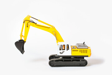 toy excavator of yellow color with a black bucket on a white background concept of construction of structures. children's toys.