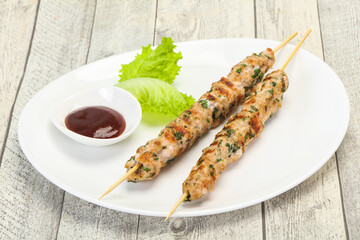 Minced pork skewer kebab with sauce