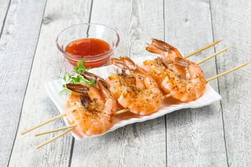 Grilled prawn skewer with sauce