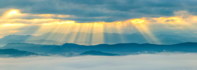 Fototapeta na wymiar Panorama view of The sun's rays and fog over the mountain in sunrise, Landscape of natural.