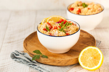 Tabouleh is an Arabic vegetarian salad made with couscous, tomatoes, parsley, onion and lemon juice. Copy space.