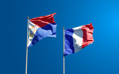 Beautiful national state flags of France and Sint Maarten together at the sky background. 3D artwork concept.