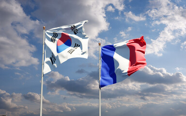 Beautiful national state flags of France and South Korea together at the sky background. 3D artwork concept.