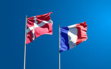 Beautiful national state flags of France and Denmark together at the sky background. 3D artwork concept.