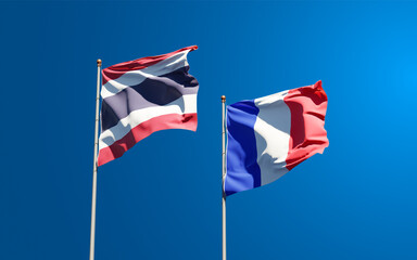Beautiful national state flags of France and Thailand together at the sky background. 3D artwork concept.
