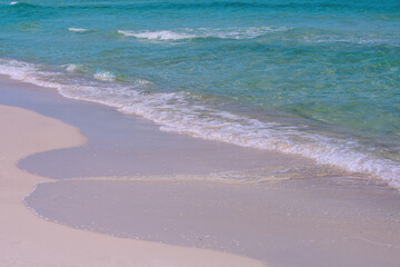 Sand beach with blue ocean and cloudscape background. Ocean blue Background.