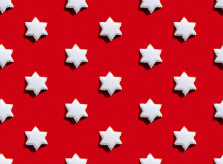 White star pattern. Red seamless background. Gingerbread cookie figure minimalist symmetrical composition wallpaper for kids. Modern contrast ornament isolated on bright.