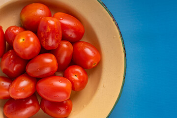 Cherry Tomatoes on rustic plate. close up cherry tomatoes