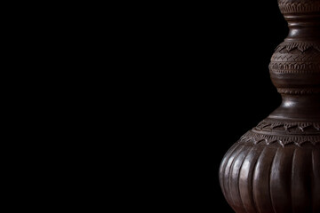 The brown  earthenware jar  isolated on black background.