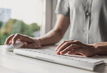 Man typing on computer keyboard closeup, businessman or student using laptop at home, panoramic...