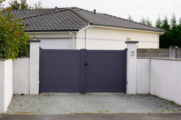 Aluminum grey metal gate of modern suburb house entrance
