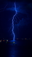Beautiful lightning bolt hitting the ocean at night.