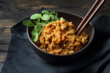 Spicy mujadra with rice, orange lentils, carrots, onions and borago sprouts