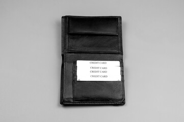 Leather black wallet for money on a gray background
