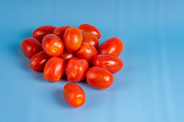 Group of Cherry Tomatoes isolated on blue background