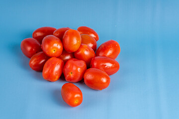 Group of Cherry Tomatoes isolated on blue background