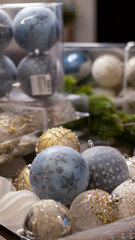 Christmas ball snow-covered fir tree, close-up, blurred bokeh background. Christmas background for a postcard. Decoration for a Christmas tree, spruce branches, New Year's toys.