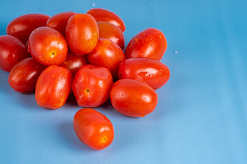 Group of Cherry Tomatoes isolated on blue background